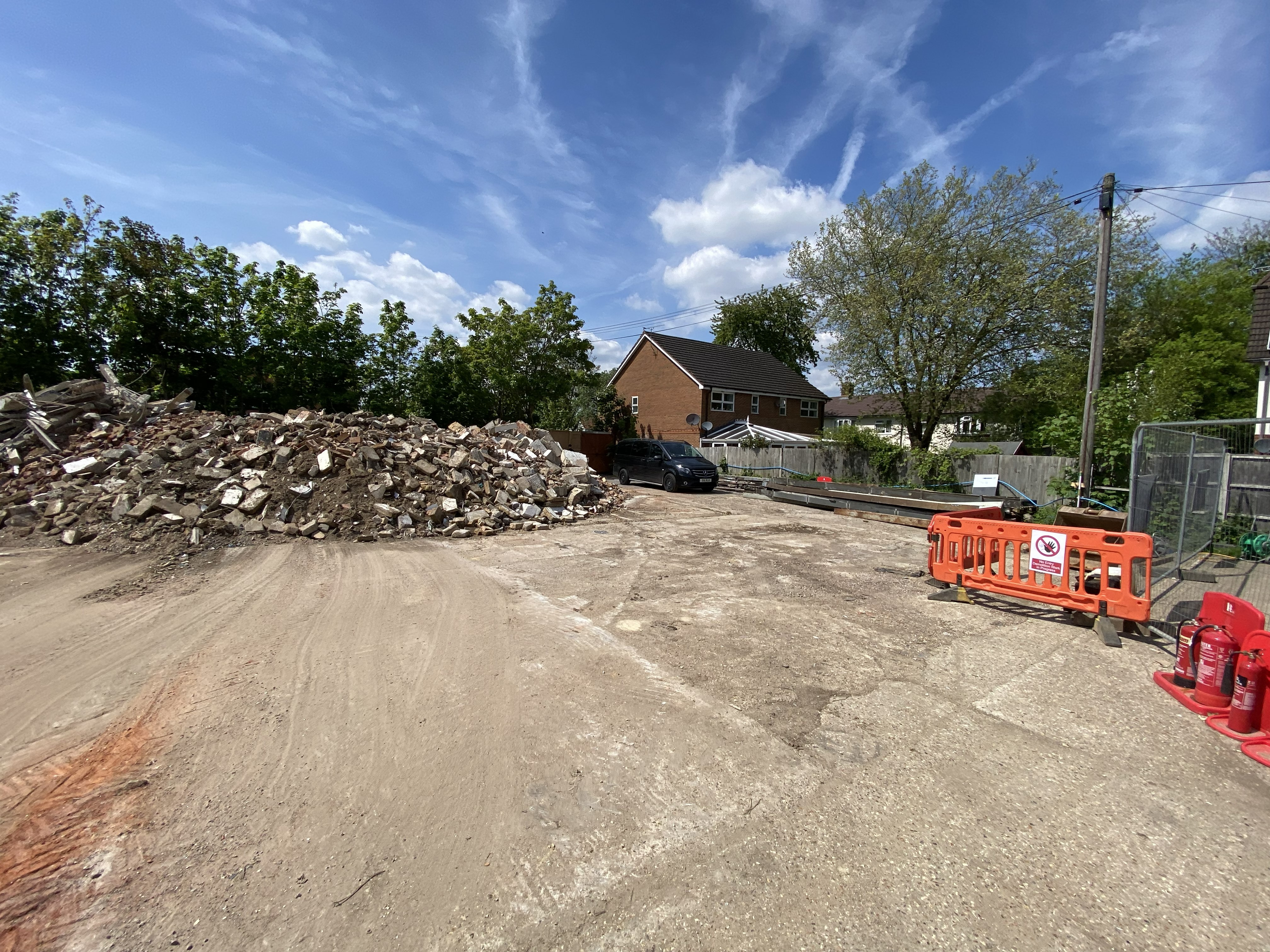 Demolition rear cleared remaining structure rubble piles