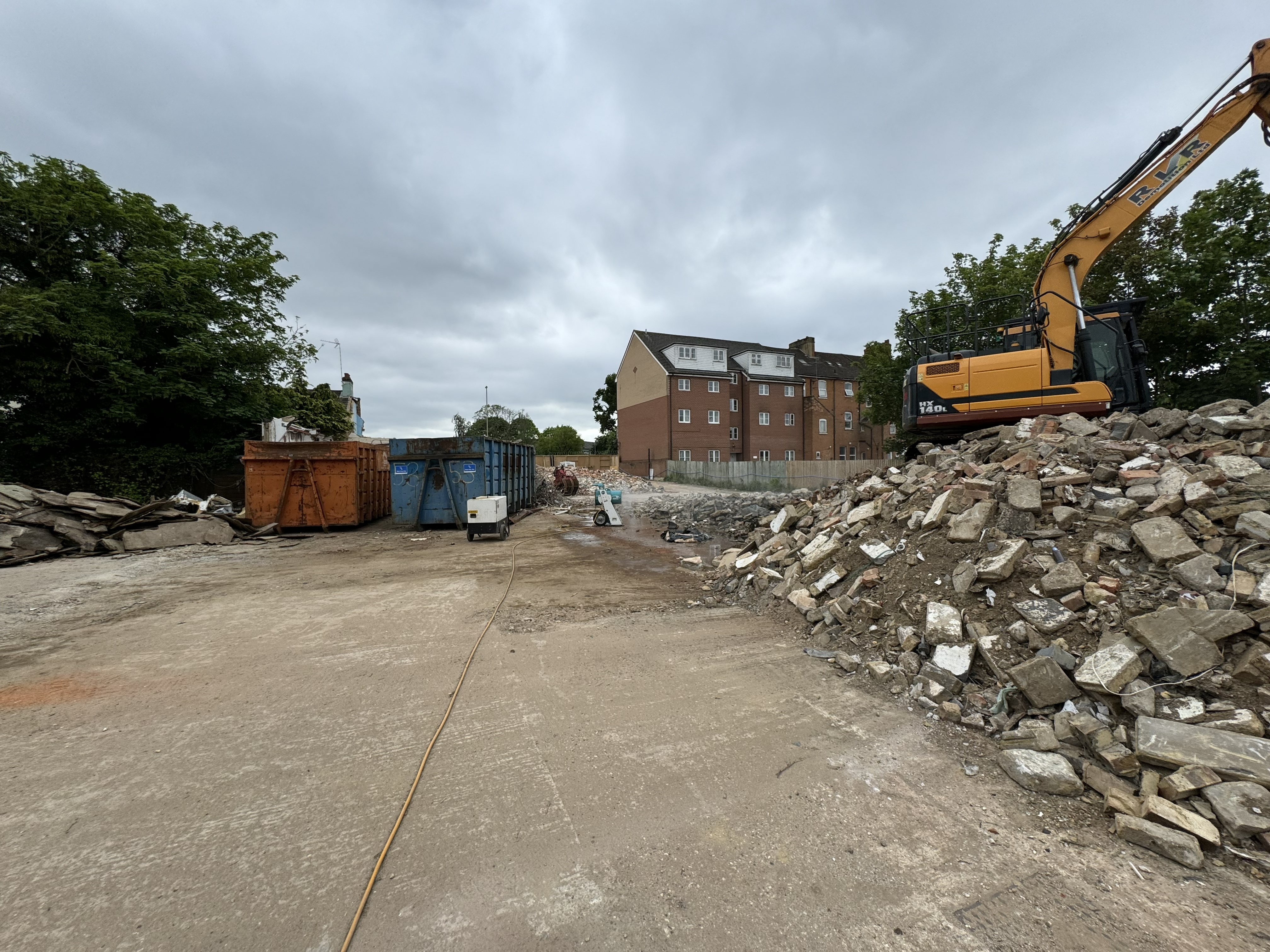 Demolition excavator on site concrete slab breaking
